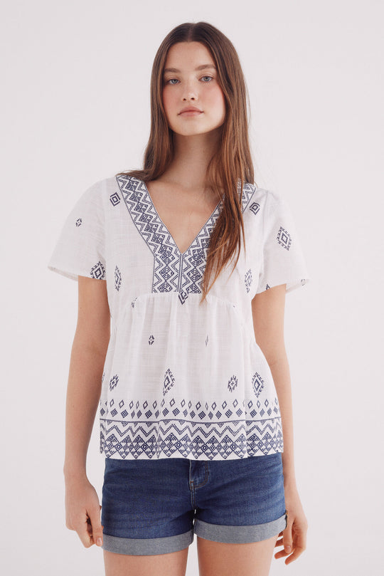 Blouse with ethnic motifs and a border neckline