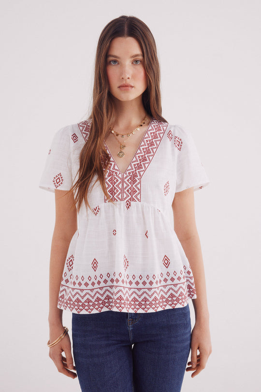Blouse with ethnic motifs and a border neckline